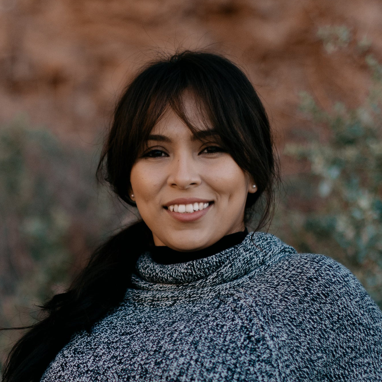 files/woman-in-a-sweater-smiles-as-she-leans-against-a-fence_79fb0d17-fb9d-4e52-83e7-ca4cdf3753ae.jpg